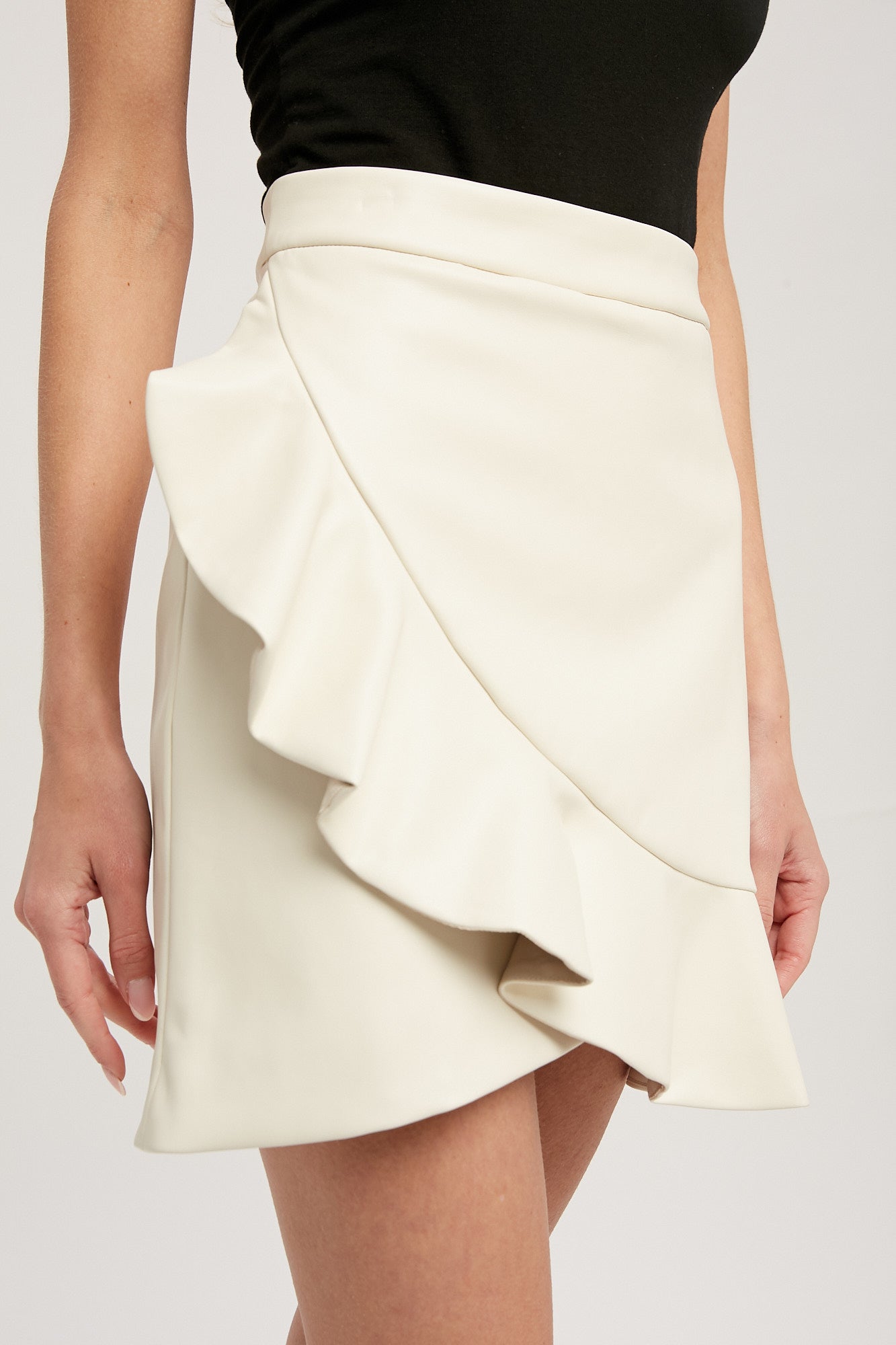The Ariana Faux Leather Ruffled Mini Skirt (Ecru)